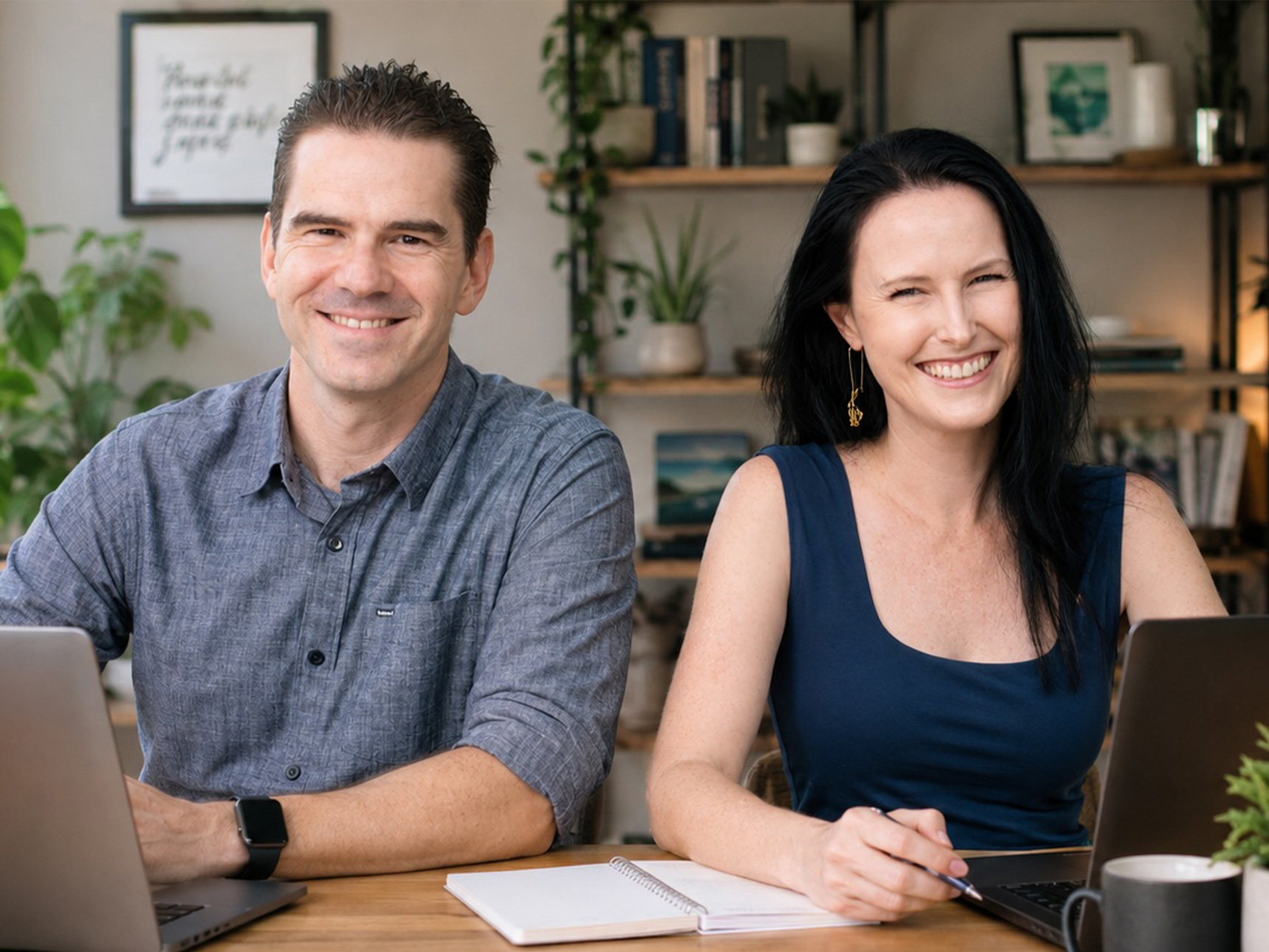 Dale and Dawn at their desk in the home office, smiling to camera.